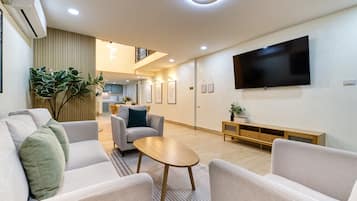 Four-Bedroom Apartment with Kitchen | Living area | LED TV