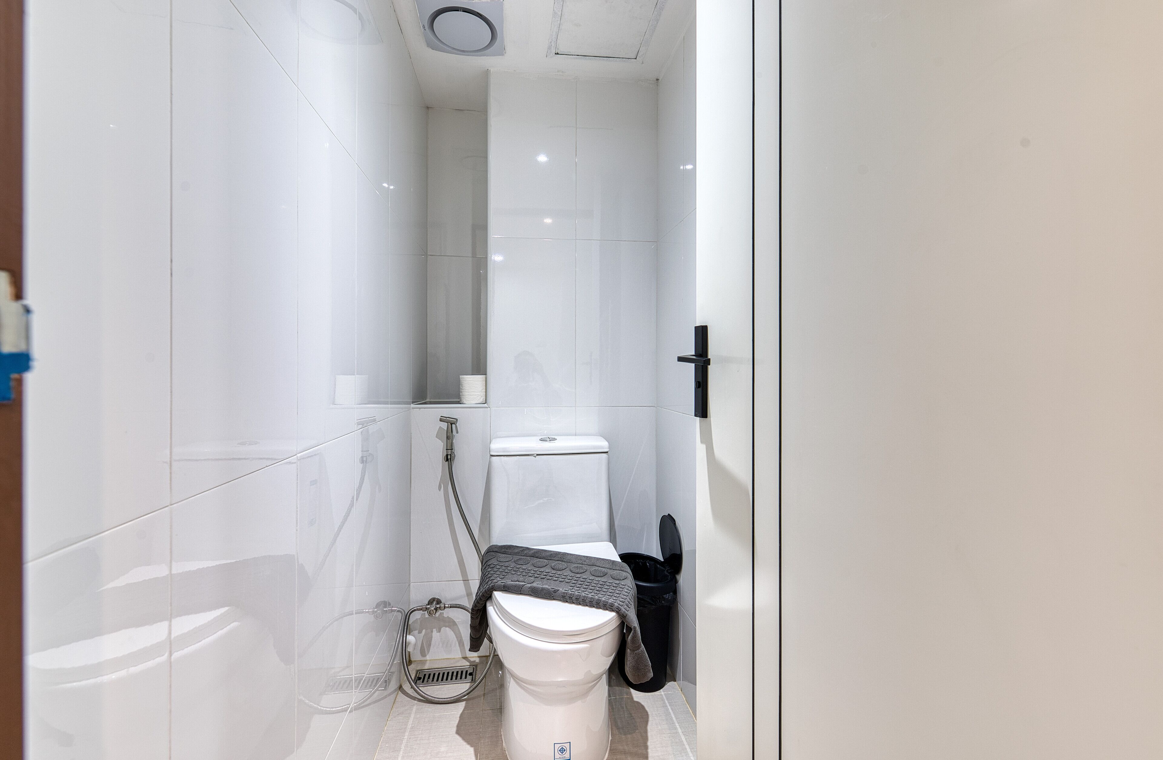 A modern bathroom with a toilet, bidet, and shower.
