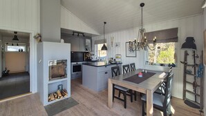 A modern kitchen with a central island, built-in oven, and pendant lighting. - Pet friendly home in Mosterhamn with sauna (Mosterhamn)