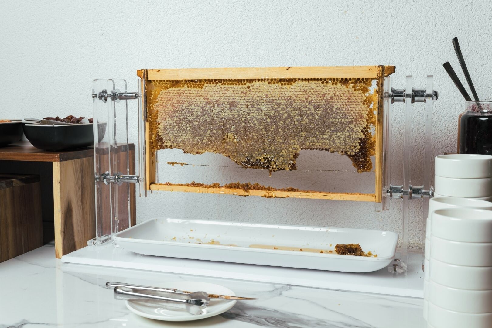 A honeycomb frame with a tray below it, likely for collecting honey.