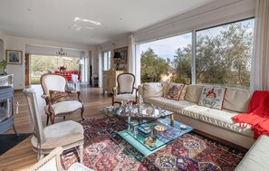 A spacious living room with a sofa, chairs, and a coffee table. - Beautiful home in Peymeinade (Peymeinade)