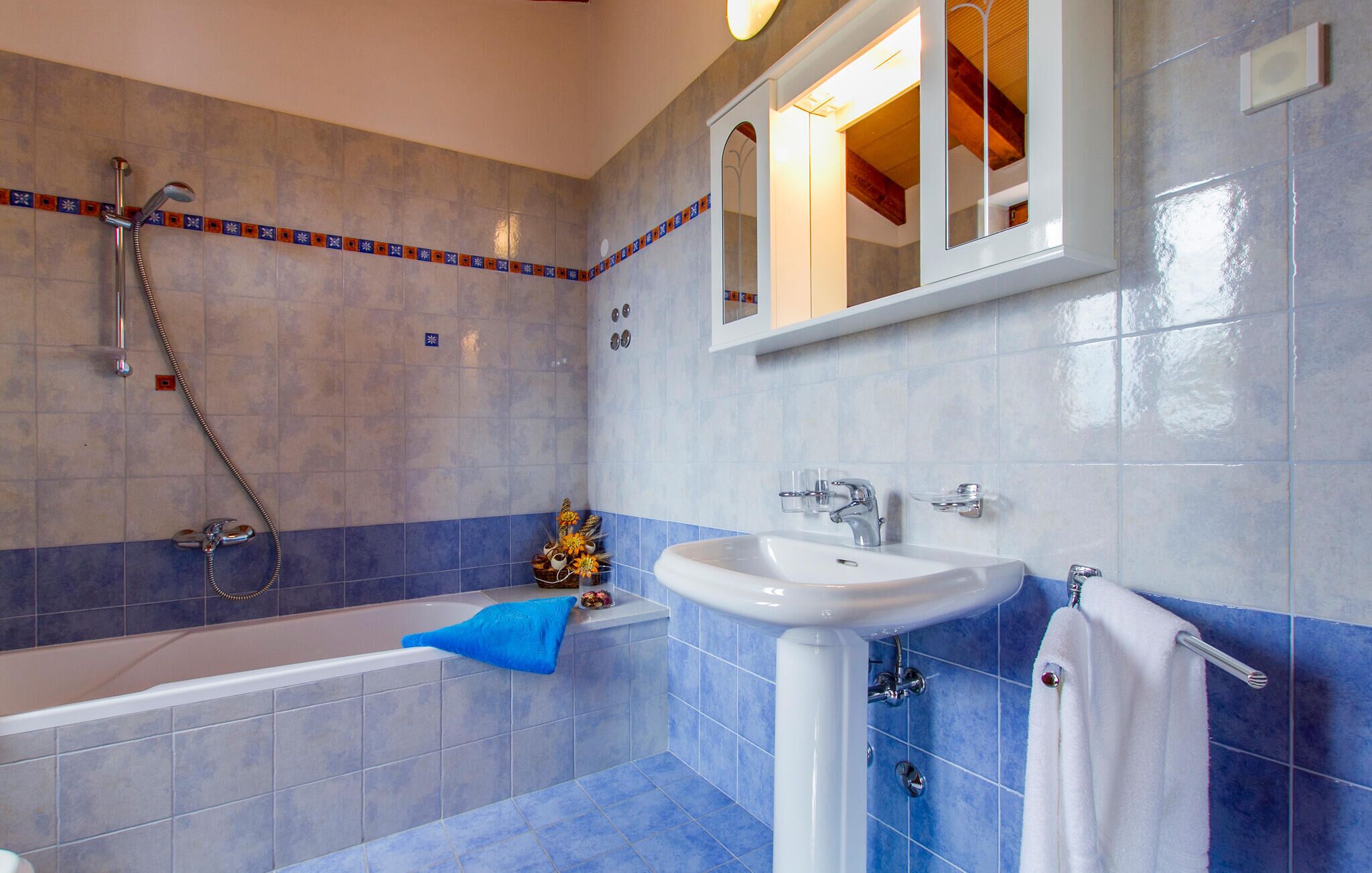 A bathroom with a bathtub, two sinks, and a shower.