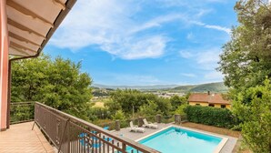 A swimming pool with a view of a rural landscape, including hills and a distant village. - Cozy home in Capolona (Capolona)