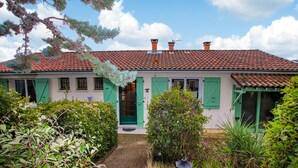A traditional house with a tiled roof, green shutters, and a brick pathway leading to the entrance. - Gorgeous home in Veyras (Veyras)