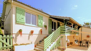A two-story house with a balcony, a staircase, and a dining area. - Gorgeous home in Veyras (Veyras)