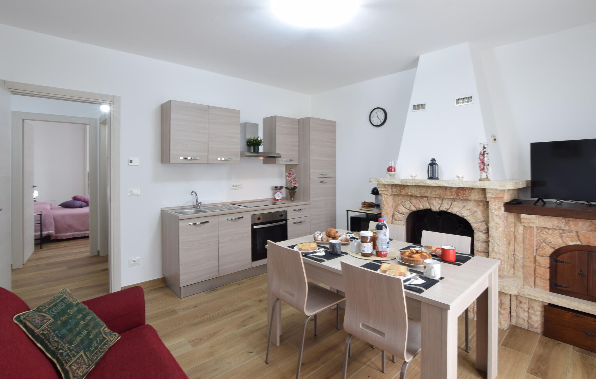 A compact living space with a kitchenette, dining area, and a fireplace.