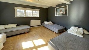A room with two beds, a radiator, and a window. - 2 bedroom nice home in Huaröd (Huaröd)