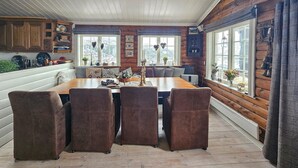 A cozy dining area with a wooden table and four upholstered chairs.