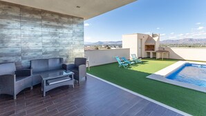 A rooftop terrace with a pool, a barbecue area, and a seating area with chairs and a table. - Beautiful home in Cox (Cox)