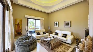 Basic Villa | Living area | 55-inch Smart TV with cable channels