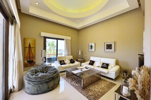 Basic Villa | Living area | 55-inch Smart TV with cable channels - Xuru Stays I Meditative & Blissful 3 BDR Villa @ Ancient Sands Private Pool (El Gouna)