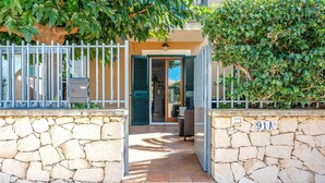 A stone-walled entrance with a metal gate, a number plaque, and a view of the interior through an open door. - 2 bedroom nice home in Marina di Modica (Marina di Modica)