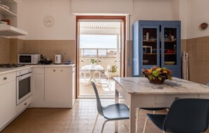 Fridge, stovetop, dishwasher, coffee/tea maker