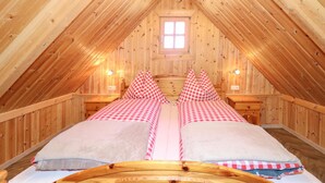 A cozy attic bedroom with two beds, wooden walls, and a small window. - Beautiful home in Stadl an der Mur (Stadl an der Mur)
