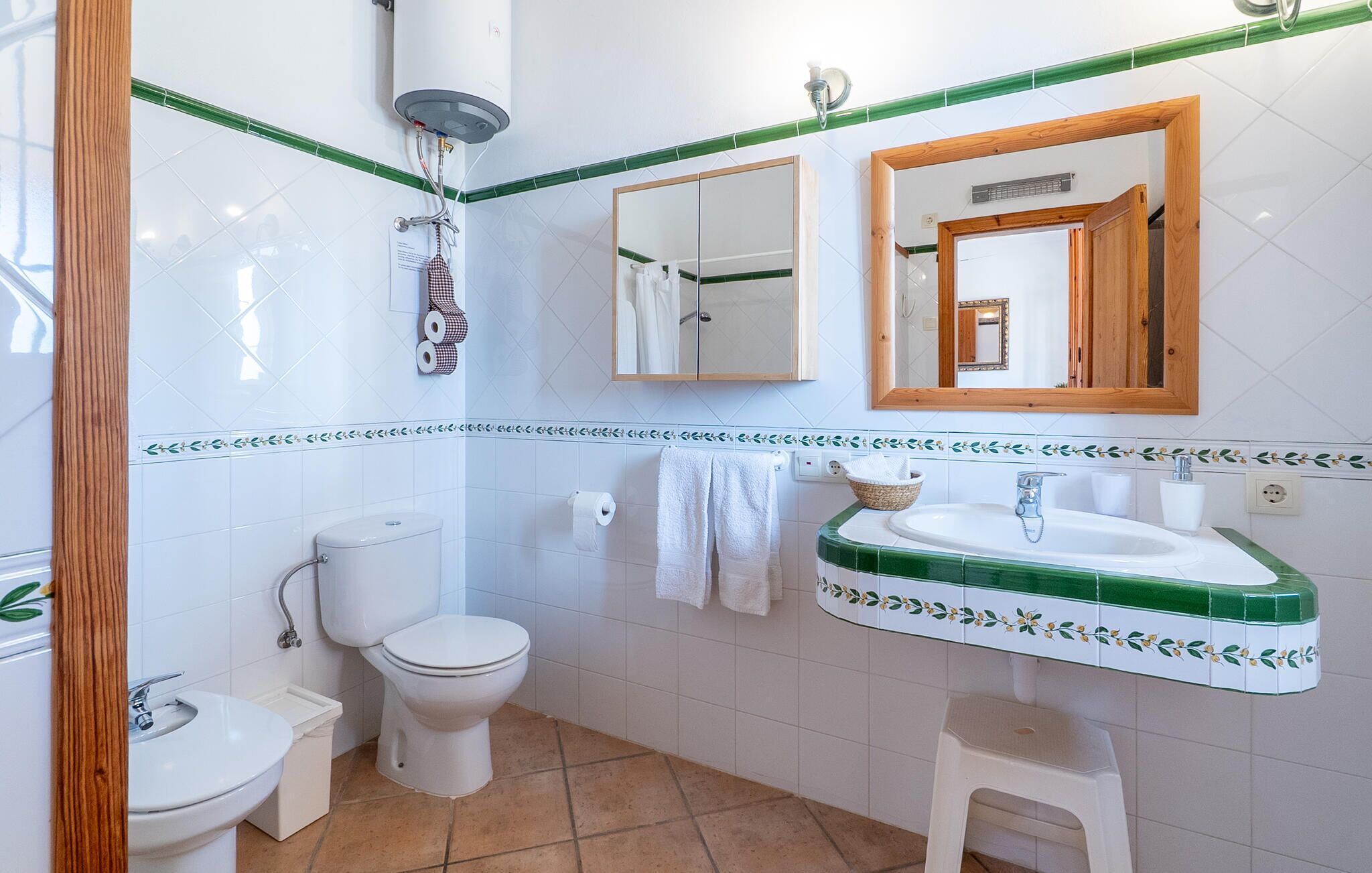 A bathroom with a toilet, sink, and shower.