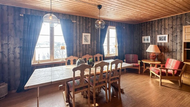 A wooden-paneled room with a dining table, chairs, and a sofa. - Awesome apartment in Rauland (Rauland)
