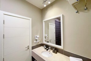 A modern bathroom with a white sink, a large mirror, and a towel hanging on the wall. - Xuru Stays I Homey 3 BDR Townhouse @ Tawila El Gouna (El Gouna)