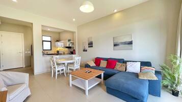 Basic Villa | Living area | 55-inch Smart TV with cable channels