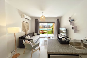 Basic Apartment | Living area | 55-inch Smart TV with cable channels - Xuru Stays I Lagoonfront Easy 1bdr @ Swan Lake El Gouna (El Gouna)