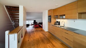 A modern kitchen with wooden cabinets, a stainless steel sink, and a built-in oven. - Amazing apartment in Søgne with WiFi (Søgne)