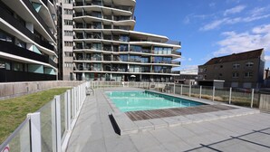 A modern apartment building with a rooftop pool area. - Awesome apartment in Oostende (Oostende)