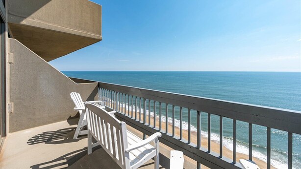 A balcony with white chairs overlooking a beach and ocean. - Century 1 unit 2502 Direct Oceanfront (Ocean City)