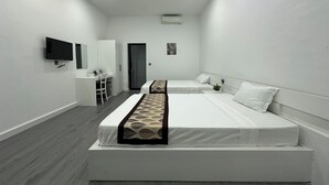 A modern hotel room with a large bed, a desk, and a TV. - Aure Residence Hotel (Sihanoukville)