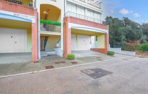 A two-story building with a covered entrance, a staircase, and a parking area. - Awesome apartment in Scarlino with WiFi (Scarlino)