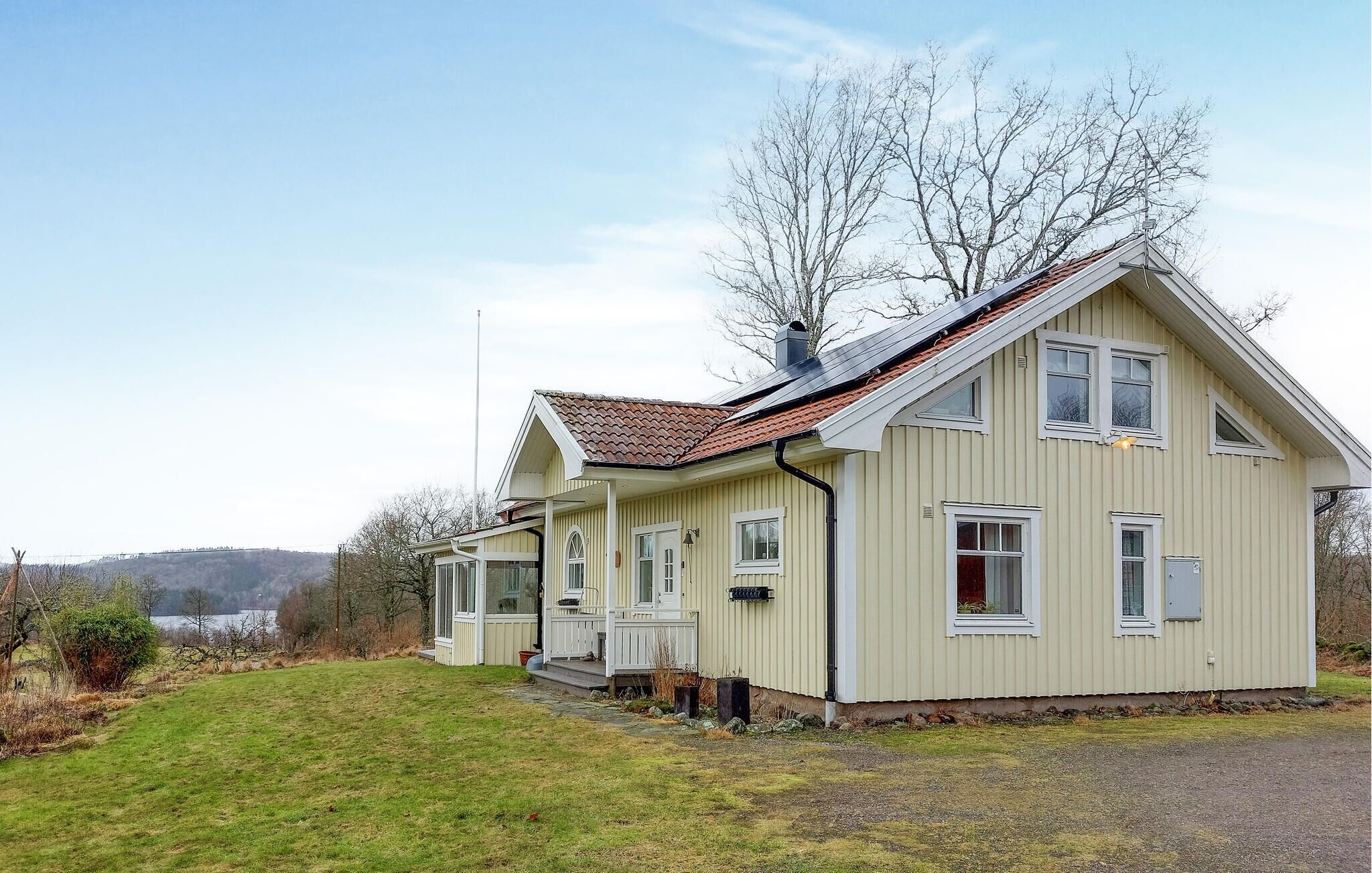 A two-story house with a sloped roof, a front porch, and a small attached garage.