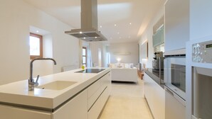 A modern kitchen with a central island, stainless steel appliances, and a minimalist design.