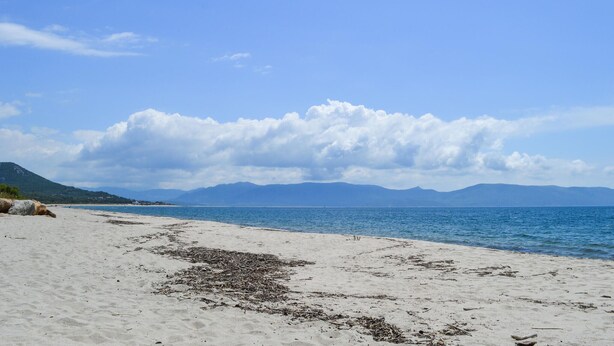 A beach with a clear sky, calm sea, and distant mountains. - 2 bedroom nice (sta)caravan in CASALABRIVA (CASALABRIVA)