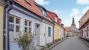 A narrow street lined with colorful buildings, each with distinct architectural styles and a variety of window designs. - 2 bedroom lovely home in Ystad (Ystad)