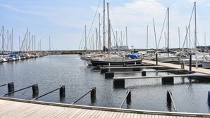 A marina with multiple boats docked, wooden walkways, and a clear sky. - 2 bedroom lovely home in Ystad (Ystad)