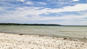 A beach with clear water and a sandy shore.