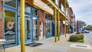 A hotel with a blue facade, large windows, and a sign reading "HOTEL CAPE CHARLES". - Walk to Beach & Central Park: Home in Cape Charles (Cape Charles)