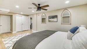 A bedroom with a bed, a ceiling fan, a rug, and a painting on the wall. - Water-view Deck: Home on Dale Hollow Lake (Albany)