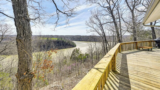 A wooden deck with a bench overlooking a valley. - Water-view Deck: Home on Dale Hollow Lake (Albany)