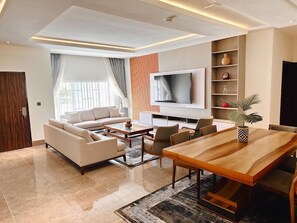 Economy Apartment, Balcony, City View | Living area - The Vattern Apartments (Abuja)