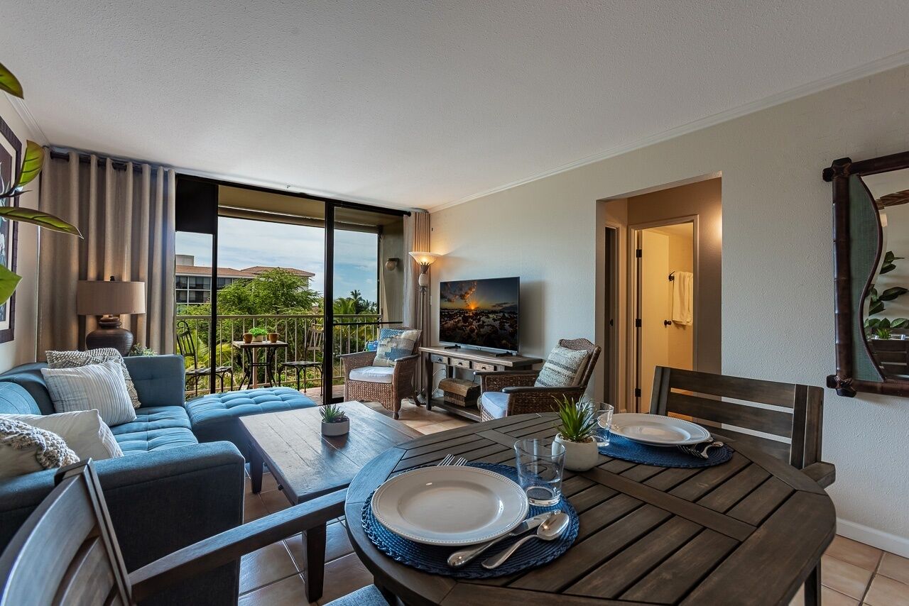 A modern living room with a sofa, dining table, and TV.