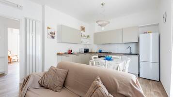 Apartment, 2 Bedrooms, Balcony, Garden View | Living area | 43-inch flat-screen TV with digital channels, TV