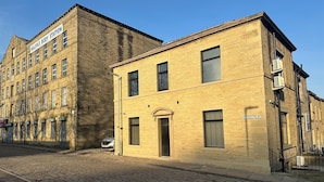 A two-story building with a sign reading "Halifax Body Station".