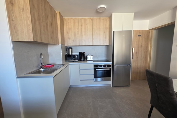 Family Apartment, Partial Sea View | Private kitchen | Highchair