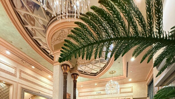A grand lobby with ornate columns, a chandelier, and a reception desk. - Alfursan Almotahida Hotel (Jeddah)