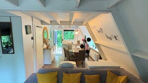 A modern interior with a sofa, dining table, and kitchen area. - Chalet Séquoia 138, Chalet Durbuy Family, nature, swimming pool dogs welcome (Durbuy)