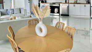 A modern kitchen with white cabinets, a stainless steel oven, and a microwave. - GardenSuite at Aqualara Villa w/ shared Rooftop Infinity Lounge Pool & Patio (Providenciales)