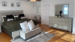 A bedroom with a bed, a dresser, a chair, a ceiling fan, and framed pictures on the wall. - Welcome Traveling Nurses and Family’s to my3 bedroom 2 bathroom cozy home (Syracuse)