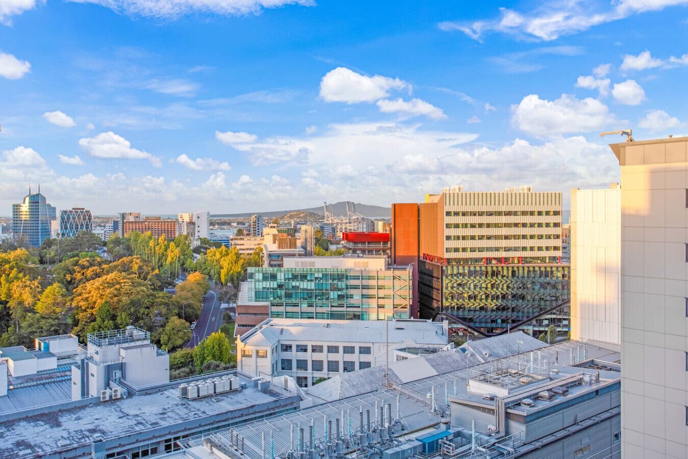 A cityscape with modern buildings, a mix of commercial and residential structures, and a clear sky.