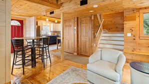 A wooden interior with a dining area, a staircase, and a living room. - Quarry Village Compound; 4BR + Hot Tub on a workin (Spruce Head)