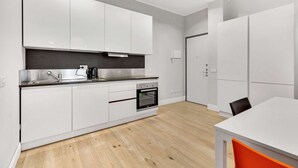 A modern kitchen with white cabinets, a stainless steel countertop, and a built-in oven. - Lepetit 3 Welcomely - Two Bedroom Apartment, Sleeps 5 (Milan)