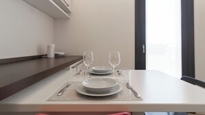 A dining table set with plates, glasses, cutlery, and a napkin. - Italianway Easy - Segesta 3 (San Siro)